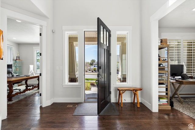 entrance foyer featuring visible vents, baseboards, and dark wood finished floors