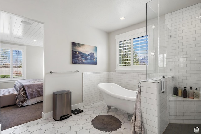 ensuite bathroom with a soaking tub, connected bathroom, recessed lighting, a stall shower, and tile patterned floors