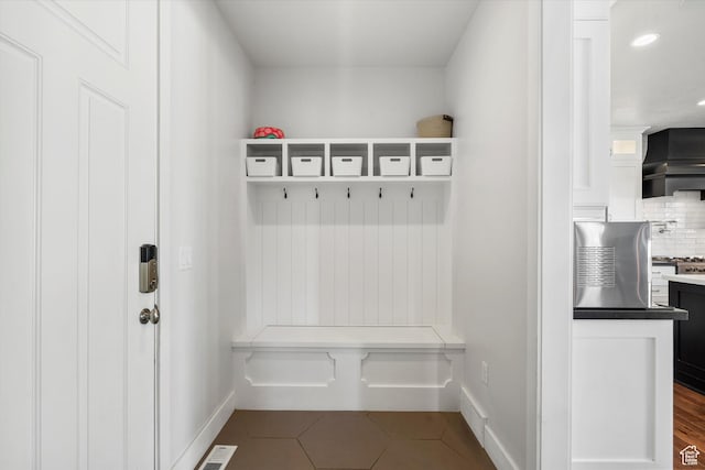 mudroom featuring visible vents, baseboards, recessed lighting, and dark tile patterned flooring