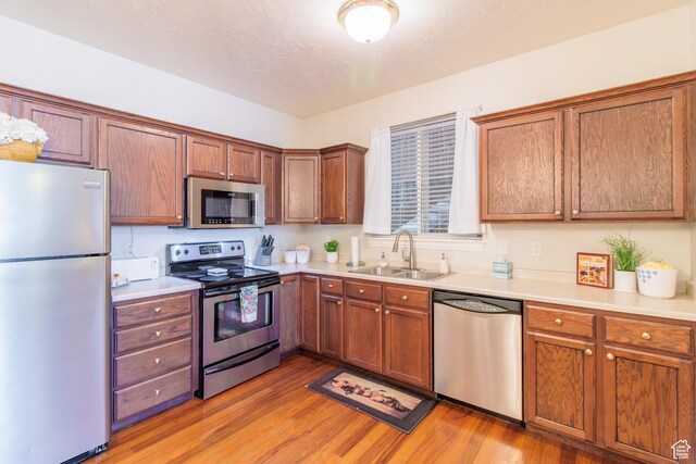 502 S 1040 E Unit 133, American Fork, UT 84003 - kitchen with a sink, light countertops, appliances with stainless steel finishes, and light wood-style floors