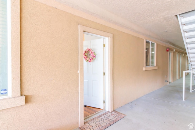 entrance to property featuring stucco siding