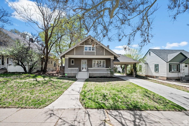 craftsman house with a carport, a front lawn, driveway, and stucco siding