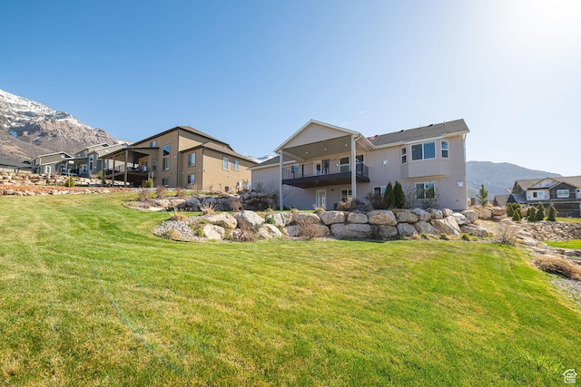 view of yard featuring a balcony and a mountain view