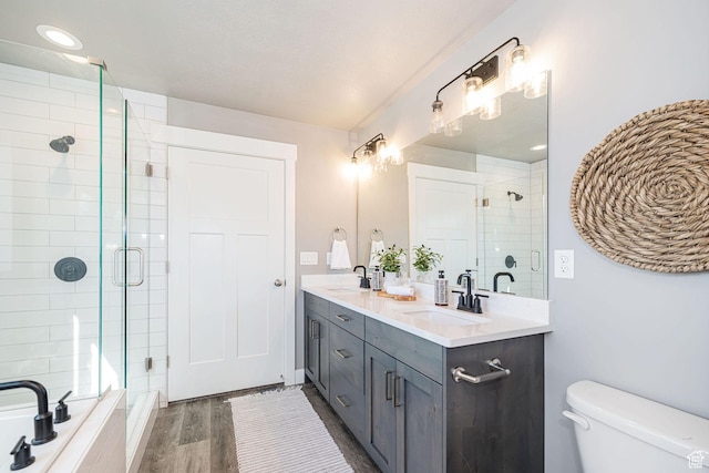 full bathroom with a shower stall, a sink, and toilet