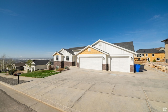 view of front facade with board and batten siding, an attached garage, brick siding, and concrete driveway