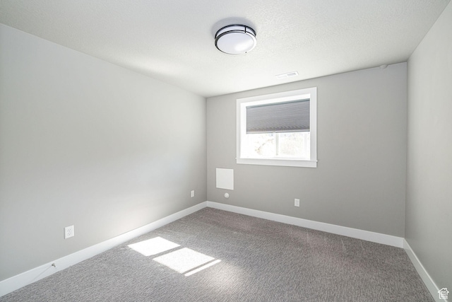 unfurnished room with carpet floors, baseboards, and visible vents