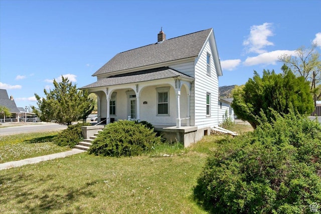 205 S Main St, Manti, UT 84642 - view of front of property featuring covered porch, a front yard, roof with shingles, and a chimney