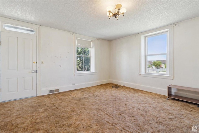 205 S Main St, Manti, UT 84642 - carpeted entryway with a textured ceiling, a chandelier, and baseboards