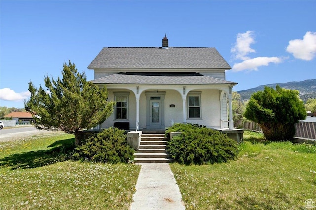 205 S Main St, Manti, UT 84642 - view of front of house featuring covered porch, roof with shingles, a mountain view, and a chimney
