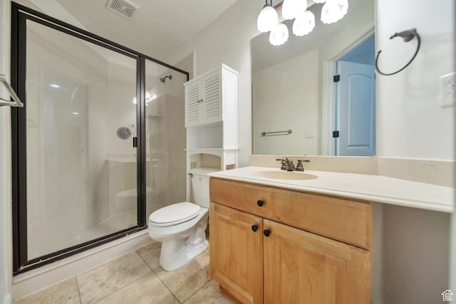 bathroom with a stall shower, vanity, toilet, tile patterned flooring, and visible vents