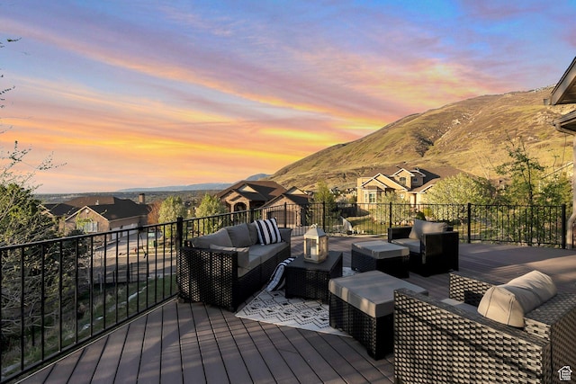 deck with an outdoor hangout area and a mountain view