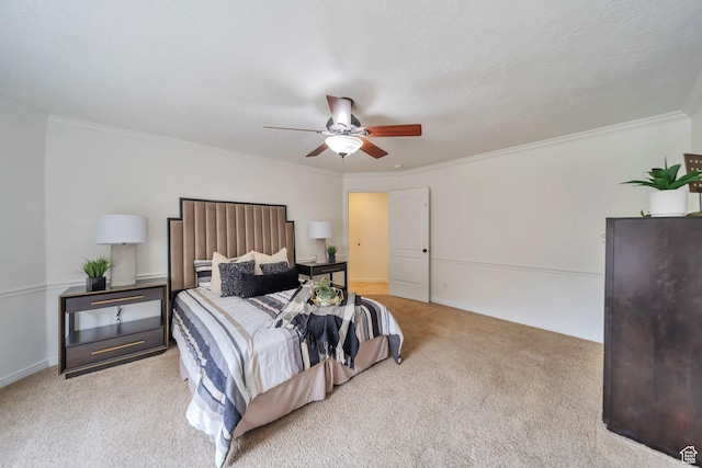 carpeted bedroom featuring ceiling fan, baseboards, and ornamental molding