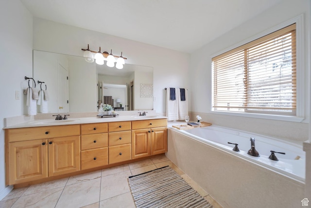 full bathroom with double vanity, a bath, tile patterned flooring, and a sink