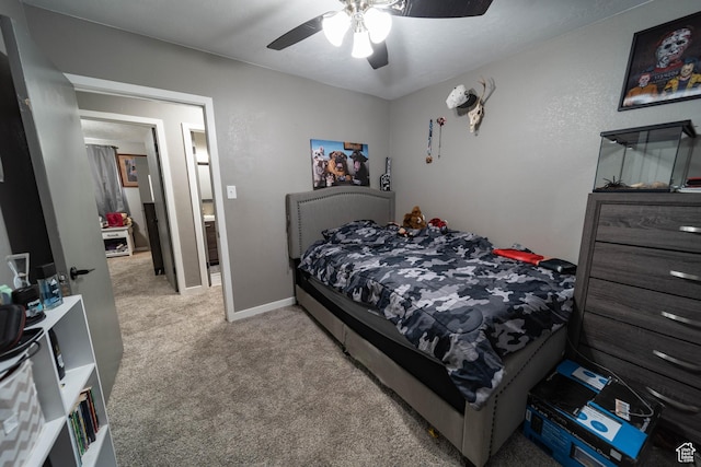 bedroom featuring light colored carpet, baseboards, and ceiling fan