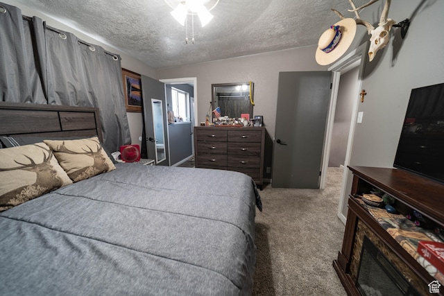 bedroom with carpet floors and a textured ceiling
