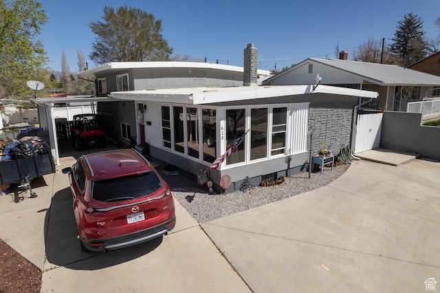 rear view of property featuring a sunroom