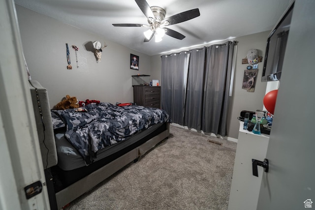bedroom with visible vents, a ceiling fan, and carpet