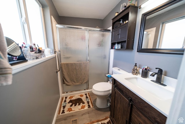 full bathroom with toilet, vanity, a shower stall, and visible vents