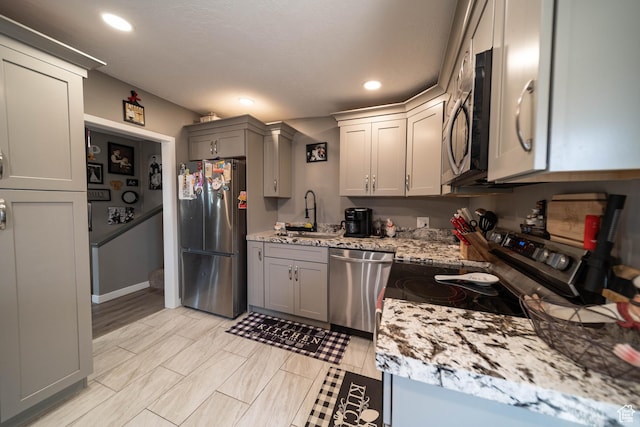 kitchen featuring a sink, gray cabinets, appliances with stainless steel finishes, and recessed lighting