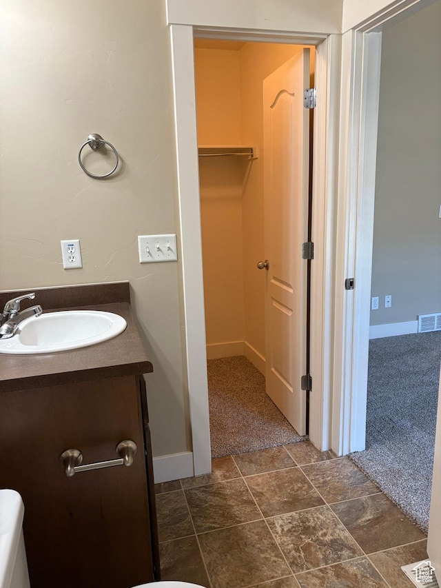 162 W Barry Links Way S, South Salt Lake, UT 84115 - bathroom with vanity, baseboards, and a walk in closet