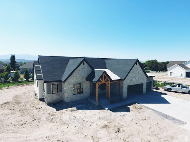 1362 S 1960 W Unit 3, Lehi, UT 84043 - view of front of house with stone siding, a garage, concrete driveway, and roof with shingles