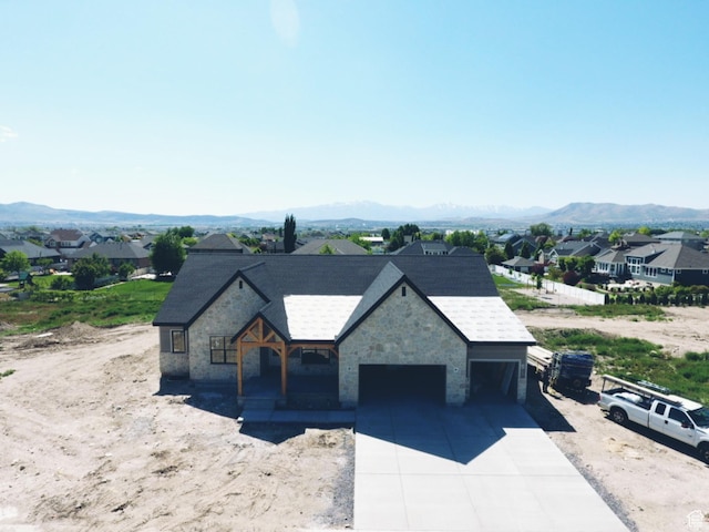 1362 S 1960 W Unit 3, Lehi, UT 84043 - view of front of home with a garage, stone siding, a mountain view, concrete driveway, and roof with shingles