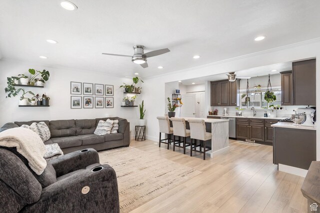 living area with recessed lighting, light wood-style flooring, and a ceiling fan