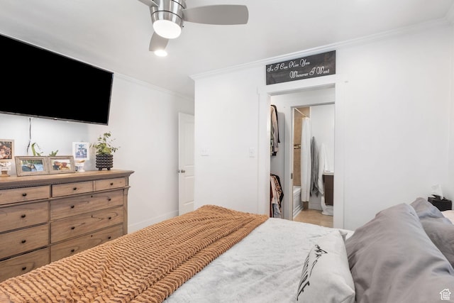 bedroom with crown molding, ceiling fan, baseboards, and connected bathroom