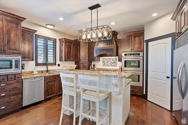 kitchen featuring custom exhaust hood, dark brown cabinetry, backsplash, and stainless steel appliances