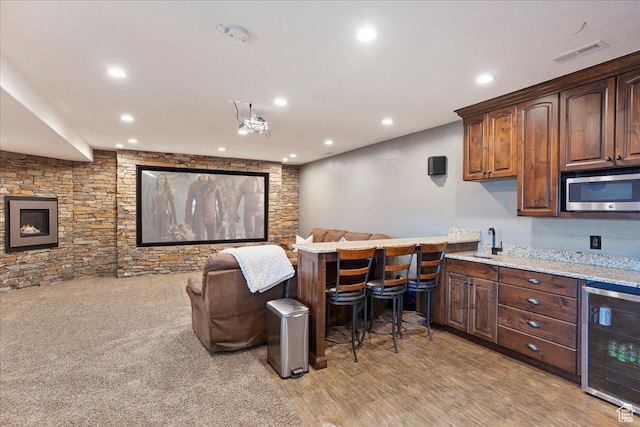 interior space with stainless steel microwave, beverage cooler, visible vents, and recessed lighting