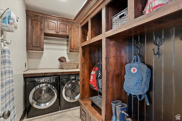 washroom with cabinet space and washing machine and dryer