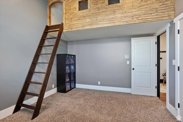 interior space featuring baseboards and carpet