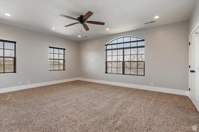 carpeted empty room featuring recessed lighting, visible vents, baseboards, and a ceiling fan