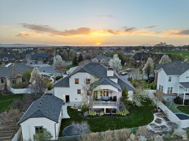 aerial view at dusk featuring a residential view