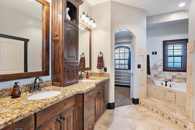 bathroom with a wealth of natural light, tile patterned flooring, and a sink