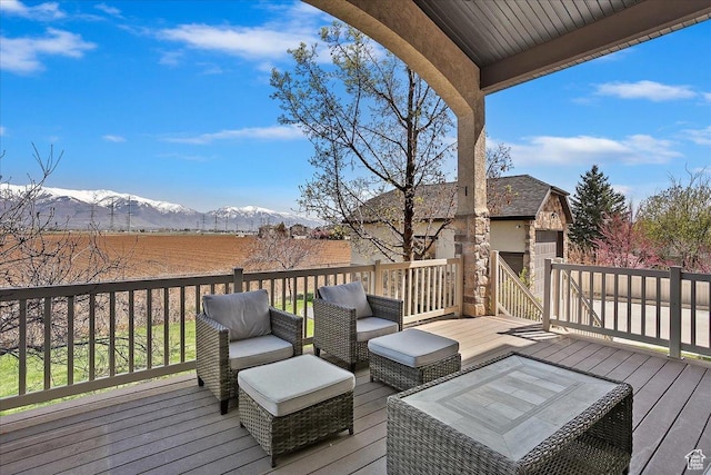 deck with a mountain view and an outdoor hangout area
