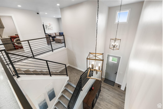 foyer entrance featuring baseboards, recessed lighting, a chandelier, and wood finished floors