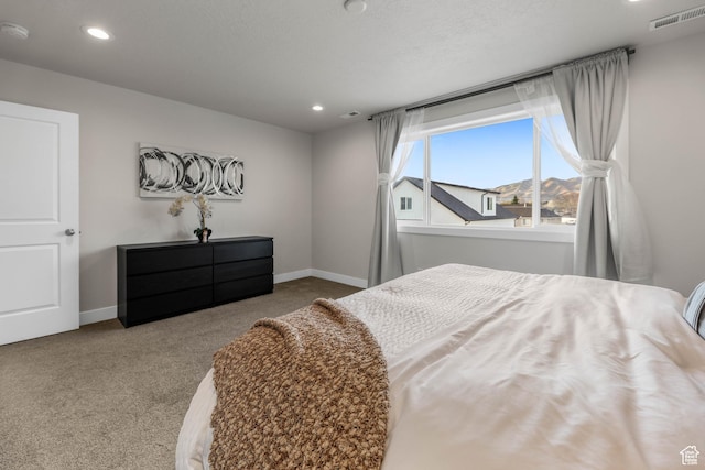 carpeted bedroom featuring baseboards, visible vents, and recessed lighting