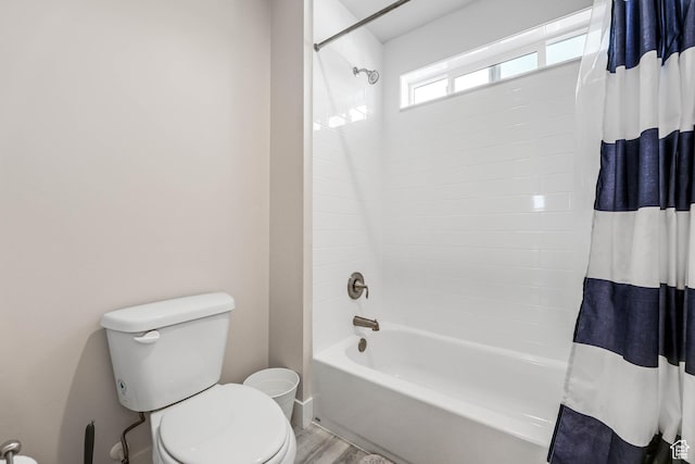 bathroom featuring toilet, shower / tub combo, and wood finished floors