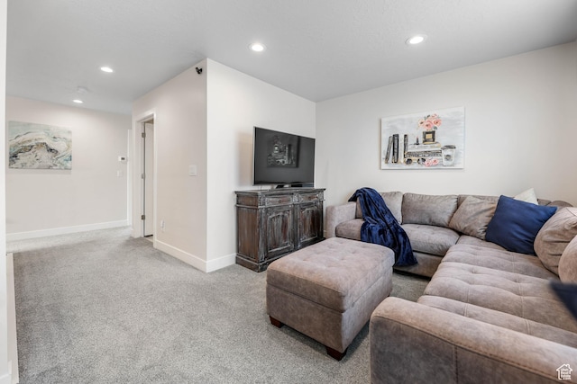 carpeted living room featuring baseboards and recessed lighting