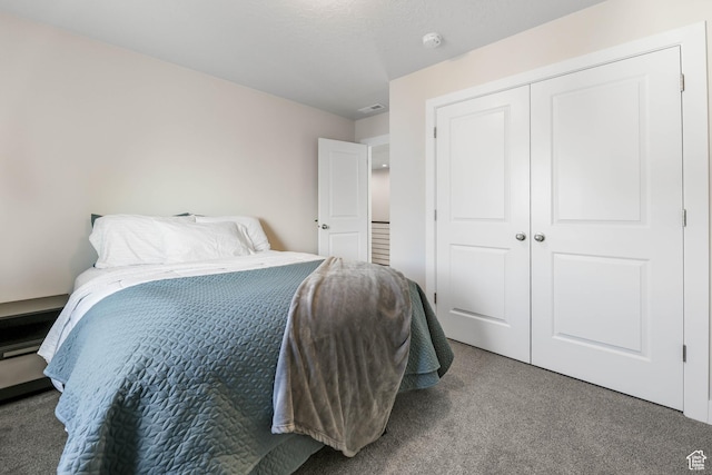 bedroom featuring carpet floors, a closet, and visible vents