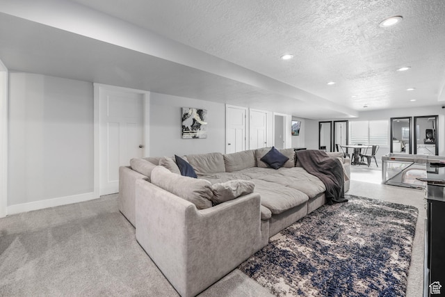 living area featuring baseboards, recessed lighting, light colored carpet, and a textured ceiling
