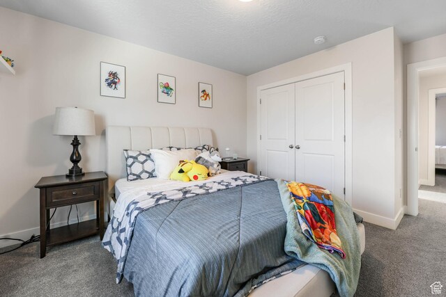 bedroom with a closet, baseboards, and carpet