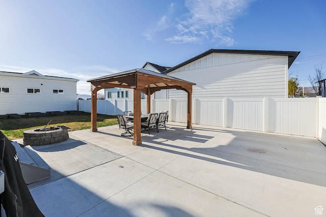 view of patio featuring a gazebo, a fenced backyard, and an outdoor fire pit