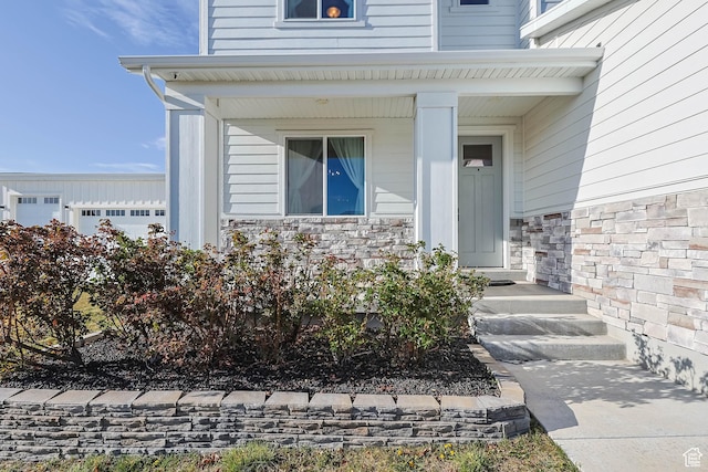 entrance to property featuring stone siding