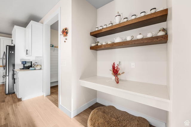 interior space featuring light wood-style floors and baseboards