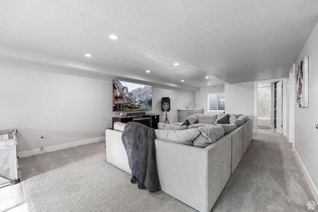 living area with recessed lighting, carpet flooring, baseboards, and a textured ceiling