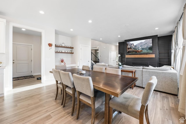 dining area with recessed lighting, stairway, and light wood-type flooring