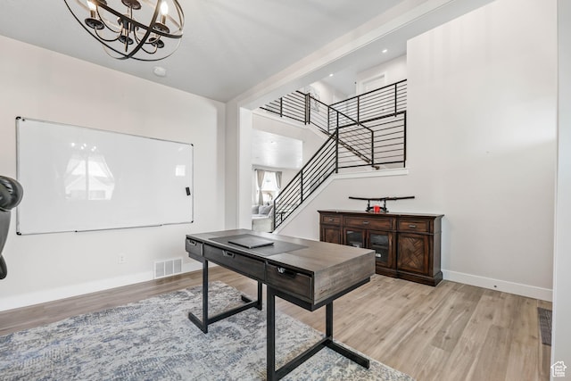 office area featuring a notable chandelier, visible vents, baseboards, and light wood-style flooring