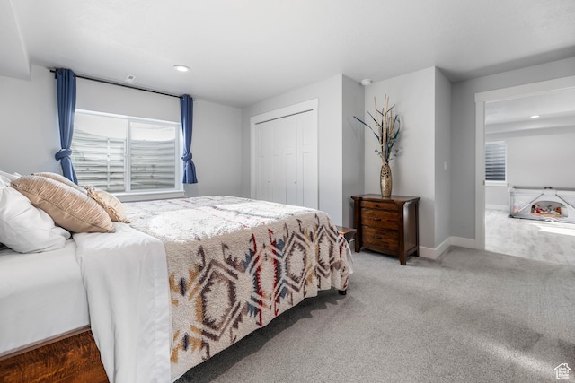 carpeted bedroom featuring a closet, baseboards, and recessed lighting